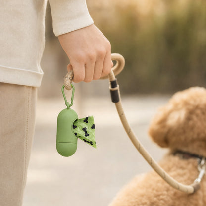 Poop bag dispenser clipped to a leash during a dog walk